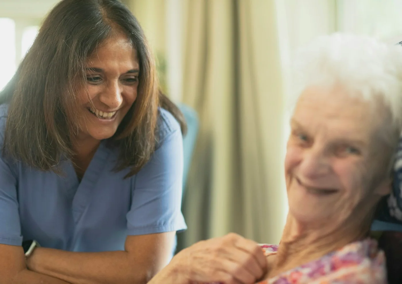 Editorial photograph of a caregiver alongside an older adult