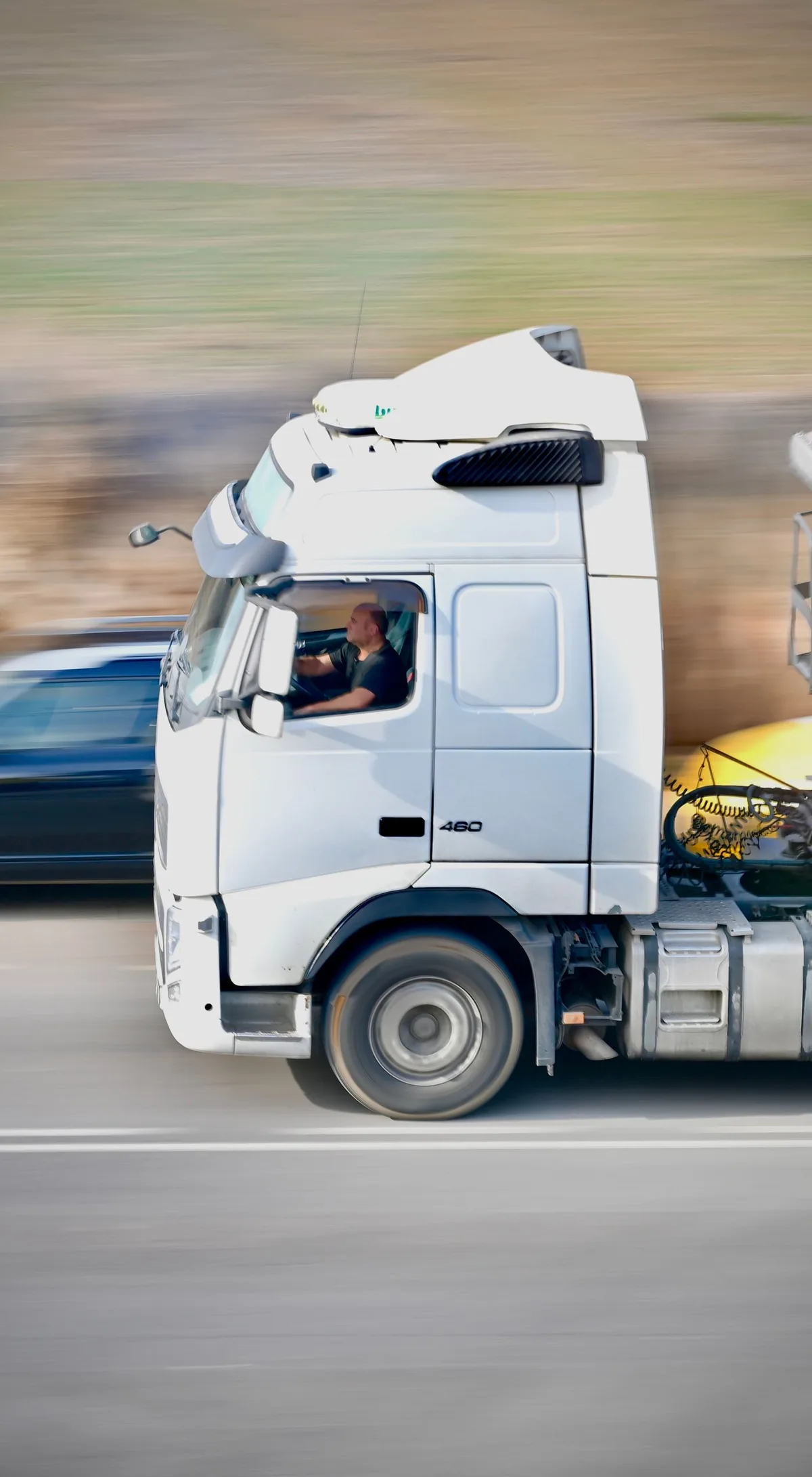 Editorial photograph of a commercial truck driver in the cab